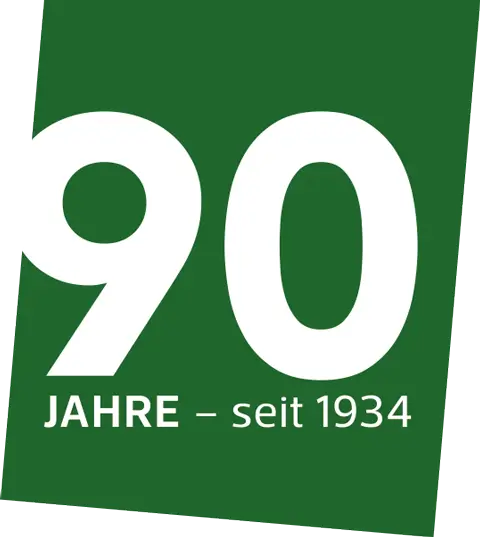 Grünes Fähnchen mit der weißen Zahl '90' und dem Text 'JAHRE - seit 1934'